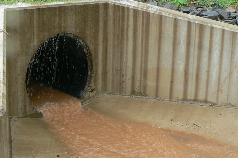 muddy water flowing out of a stormwater outfall